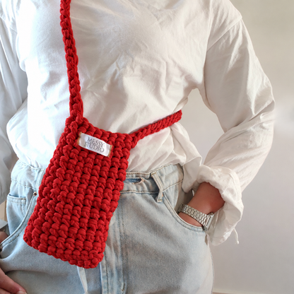 Red crochet crossbody bag worn with a white shirt