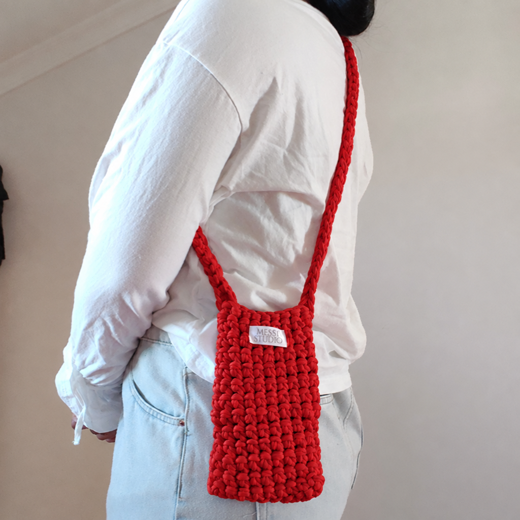 Red crochet crossbody bag, worn side view
